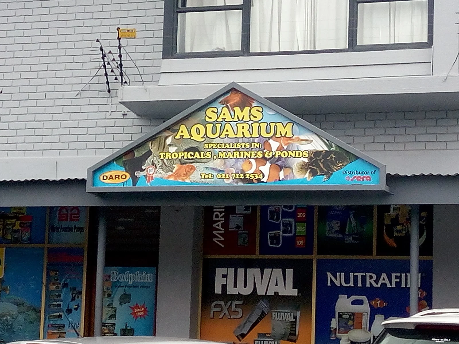 The older Sam's Aquarium sign above the shop entrance